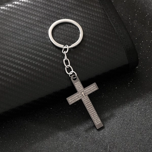 Silver gothic cross keychain with Spanish Lord's Prayer engraving on black wallet