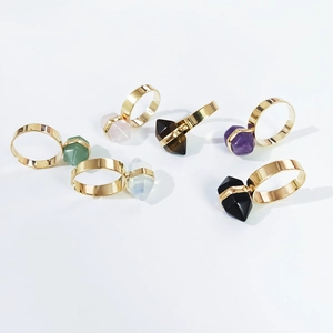 Close-up of hexagonal crystal stone rings with adjustable gold-plated bands in six colors