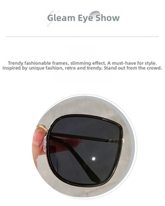 Detail of square oversized sunglasses with classic black lenses and gold metal frames