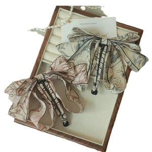 Elegant floral ink-wash bow hair clip in beige and pink fabric for high-end ponytail style
