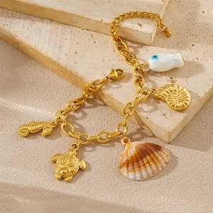 Gold beach theme charm bracelet with sea turtle, seahorse, and shell pendants for summer
