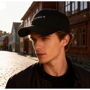 Close-up of white letter embroidery on a premium black cotton twill baseball cap