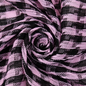 Macro detail of breathable pink and black striped fabric folded into a floral rose shape