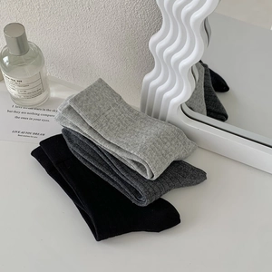 Detailed knit texture of breathable cotton mid-calf socks in black and grey tones