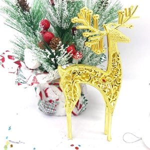 Golden Christmas reindeer ornament featuring festive red berries and pine needles