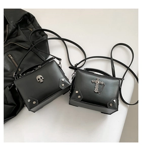 Detail shot of black biker crossbody bags with metal skull and cross rivets decoration