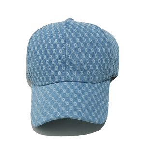 Detailed front view of light blue denim baseball cap featuring square distressed holes