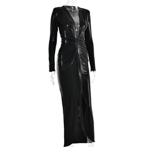 Détail de robe en cuir noir brillant montrant un décolleté en V profond et taille nouée