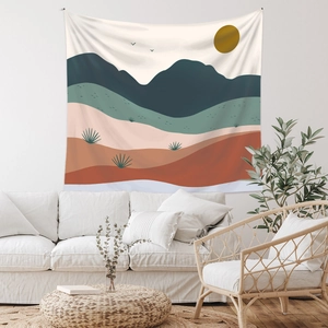 Detail of bohemian tapestry featuring abstract mountain landscape on a cozy white wall