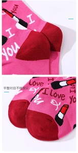 Detailed view of pink socks featuring reinforced red heel and toe with durable stitching