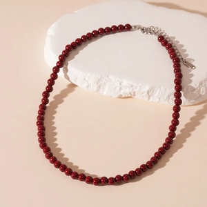 Dettaglio della collana di perle di cristallo rosso scuro con chiusura in argento