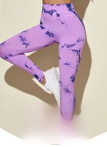 Macro detail of high-waist purple tie-dye seamless yoga pants showing elastic fabric texture