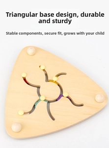Detail of triangular wooden puzzle toy showing sliding yellow beads and colorful tracks