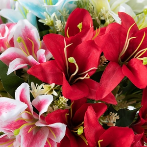 Close-up of artificial lily bouquet with vibrant red, pink, and white flower petals