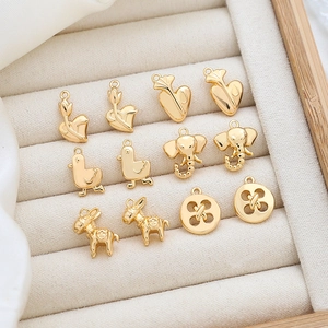 Macro shot of assorted 18K gold-plated animal and flower charms for DIY jewelry making