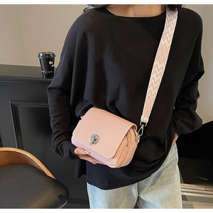 Chic pink woven mini crossbody bag with wide strap and lock closure, perfect for daily wear.
