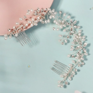 Handmade bridal hair vine with silver rhinestones and pearls on a soft bicolor background