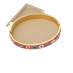 Retro gold stainless steel bangle with vibrant red and blue enamel eye patterns