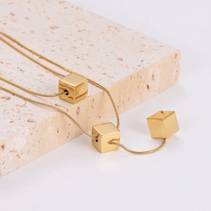 Elegant gold-tone double-layer snake chain necklace featuring three minimalist square cubes