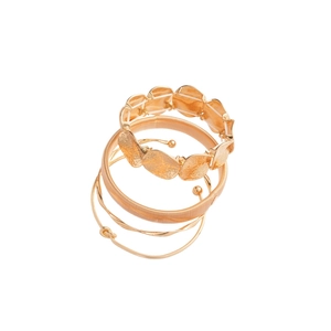 Set of 4 metallic irregular gold-plated stackable bangles featuring hammered textures