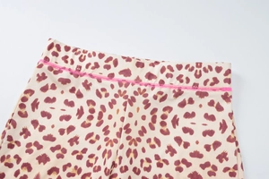 Detailed view of high-waist leopard print yoga shorts with pink stitching details