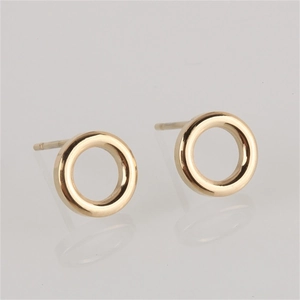 Macro shot of minimalist gold-plated hollow circular stud earrings in stainless steel
