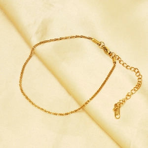 Elegant 18K gold-plated star anklet on beige silk fabric with adjustable lobster clasp