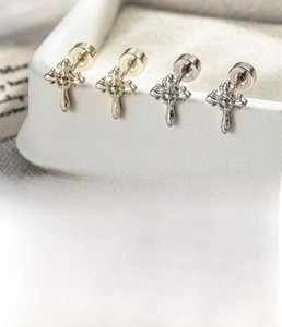 Detail view of iris cross stud earrings in silver and gold finish with screw back design