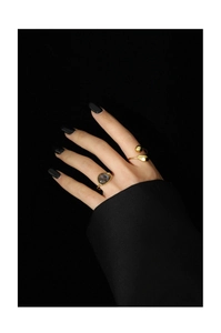 Macro shot of gold plated open ring set with irregular moonstone on a model hand