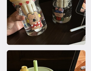 Detail showing high temperature resistant glass cups with cartoon bears and tea filters