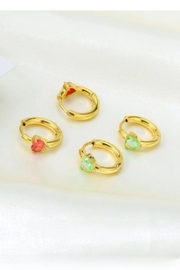 Detailed shot of gold-plated hoop earrings with red heart and green pear zircons
