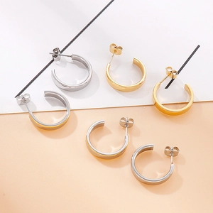 Minimalist C-shaped stainless steel stud earrings in polished gold and silver finishes