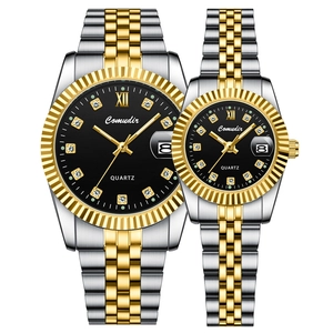 Detail of couple watches with luminous calendar and two-tone gold and silver steel band