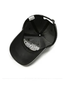 Detail view of cotton baseball cap interior with wash label and metal strap buckle
