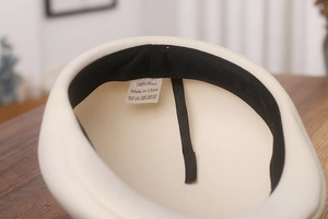 Detailed interior of wool beret showing sweatband and adjustable drawstring