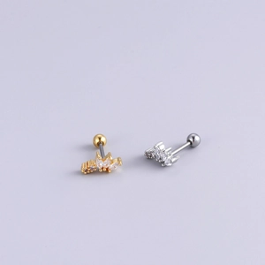 Detailed macro view of gold and silver flower earrings with white cubic zirconia crystals