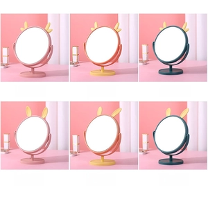 Detail of cartoon cat and deer ear makeup mirrors in pink, yellow, and navy blue options