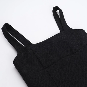 Close-up of the square neckline and textured tweed fabric on a black elegant dress
