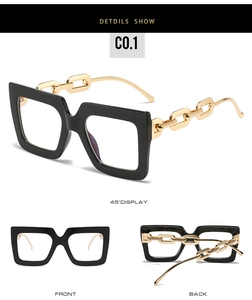 Detailed views of square oversized glasses frames with gold chain link temples and black rims