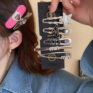 Detailed close-up of Y2K heart and star hair clips set with sparkling rhinestones