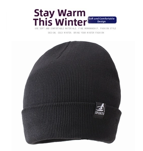 Close-up of black knitted beanie with thick winter fleece lining and sports logo tag
