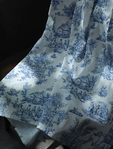 Detailed view of vintage blue floral Toile de Jouy pattern on premium cotton apron fabric