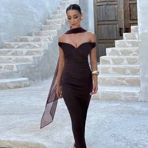 Detailed view of the off-shoulder neckline and matching scarf on a pleated fishtail gown