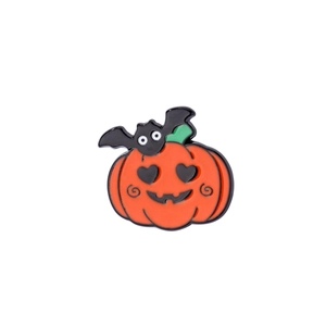 Halloween pumpkin enamel pin with heart eyes and black bat icon on white background