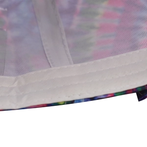 Macro detail of inner white reinforced stitching on the colorful graffiti cotton baseball cap