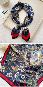 Detail of vintage floral pattern on navy silk scarf with elegant red contrasting border