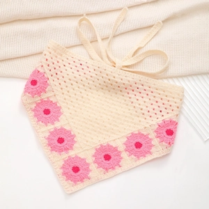 Close-up of handmade crochet triangle bandana with pink sunflower edge on white mesh