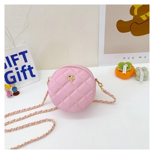 Detailed macro view of pink quilted round bag with gold floral hardware and chain strap
