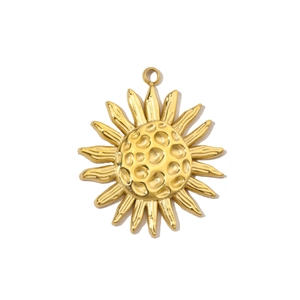 Macro shot of sun-shaped stainless steel pendant in bright gold finish with loop