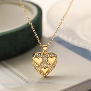 Elegant gold heart pendant necklace with zircon crystals on a classic link chain
